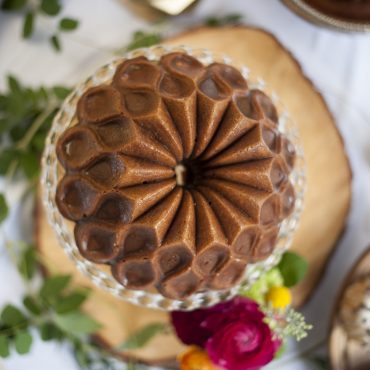 Golden bundt cake baked in Nordic Ware Crown bundt pan showing detailed geometric crown pattern design