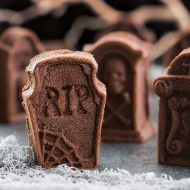 Nordic Ware aluminum tombstone cakelet pan with chocolate cakes shaped like gravestones, detailed RIP designs