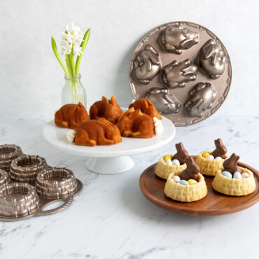 Nordic Ware aluminum Baby Bunny cake pan with baked bunny cakes on stand and Shortcake Basket pans displayed