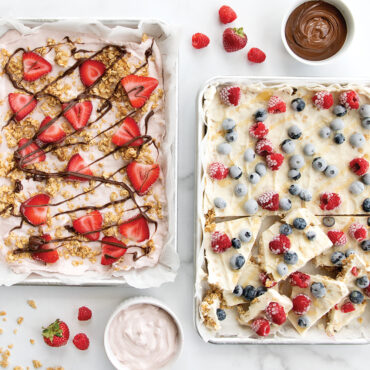 Two Nordic Ware aluminum quarter sheet pans with colorful frozen yogurt bark pieces, natural silver finish