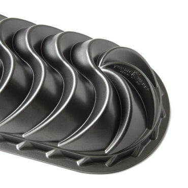 Nordic Ware Heritage aluminum loaf pan with decorative swirled exterior pattern, dark bronze finish