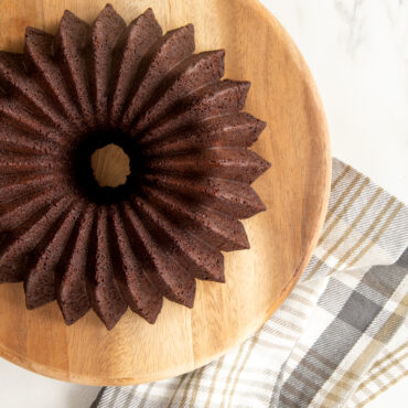 Dark chocolate bundt cake baked in Nordic Ware Brilliance pan, displaying intricate geometric ridged pattern