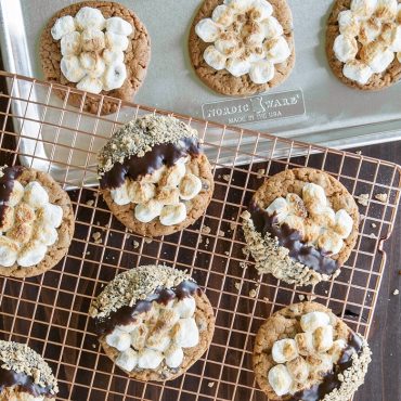 Golden s'more cookies cooling on Nordic Ware large copper-plated wire cooling rack over sheet pan