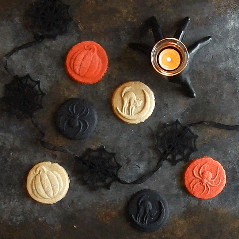 Nordic Ware Halloween cookie stamps creating decorated sugar cookies with pumpkin, bat, and ghost designs
