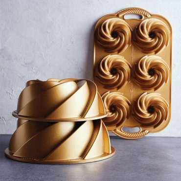 Nordic Ware gold aluminum Heritage bundt pans showing spiral fluted design in 6-cup mini and large sizes