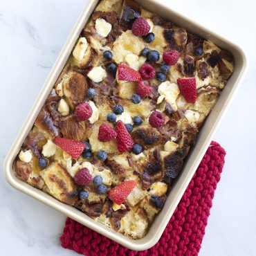 Golden baked oatmeal with fresh berries and banana in Nordic Ware aluminum rectangular cake pan