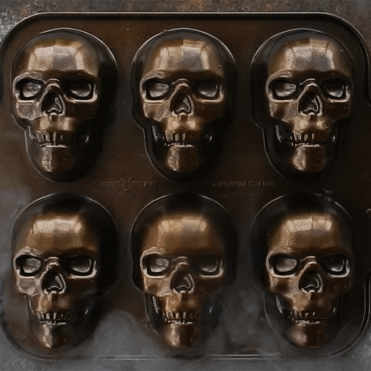 Nordic Ware aluminum Haunted Skull Cakelet Pan with six skull-shaped cavities, animated smoke effect overlay