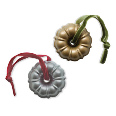 Two miniature cast aluminum bundt pan ornaments, one gold and one silver finish, with detailed fluted ridges