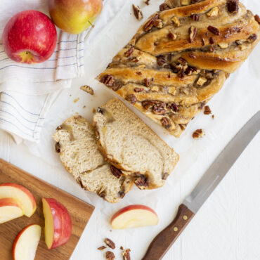 Braided apple babka loaf in Nordic Ware aluminum loaf pan, sliced to show swirled filling