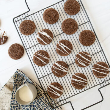 Nordic Ware nonstick high-sided baking tray with wire rack holding golden baked chocolate chip cookies