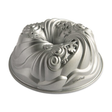 Nordic Ware Let It Snow aluminum bundt pan with intricate snowflake and winter pattern design, silver finish