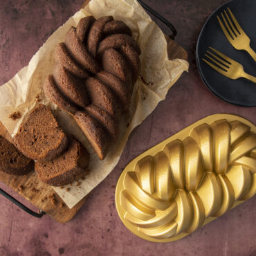 Golden braided loaf cake baked in Nordic Ware aluminum braided loaf pan, showing detailed rope pattern