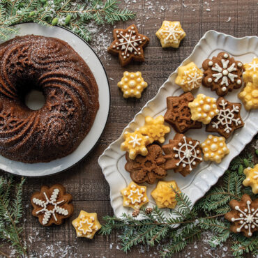 Snow-dusted bundt cake and small snowflake-shaped bites from Nordic Ware Frosty Flakes pan on winter display