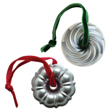 Two silver metallic bundt pan ornaments, one original fluted design and one heritage pattern with detailed ridges