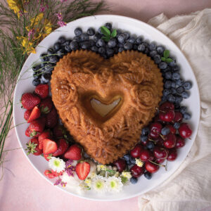 Baked floral bundt on plate with fruit