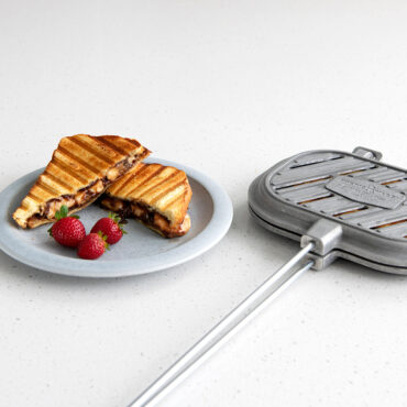 Nordic Ware cast aluminum campfire griller with grilled Nutella sandwich showing golden-brown grill marks