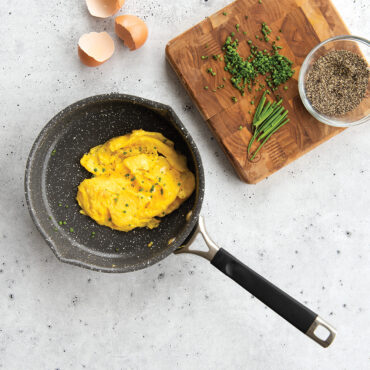 Fluffy scrambled eggs in Nordic Ware Verde ceramic nonstick 8-inch skillet, green exterior with cream interior