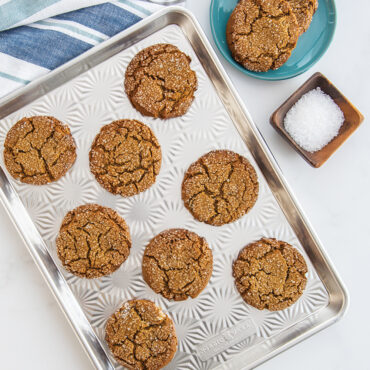 Star-shaped gingerbread cookies baked golden brown on Nordic Ware aluminum Naturals Vintage Starburst half sheet pan