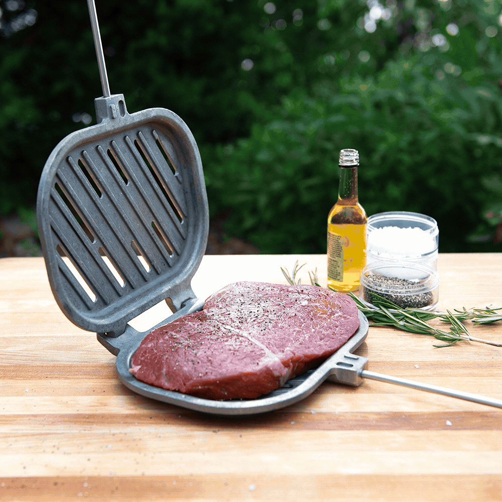 Nordic Ware cast aluminum campfire griller with hinged basket design, shown from prep through outdoor cooking over flames
