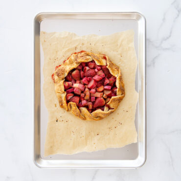 Nordic Ware aluminum half sheet pan with golden-brown galette on parchment paper, natural finish