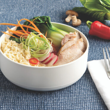 White ceramic soup bowl with wide rim and deep rounded interior, part of Nordic Ware two-bowl set