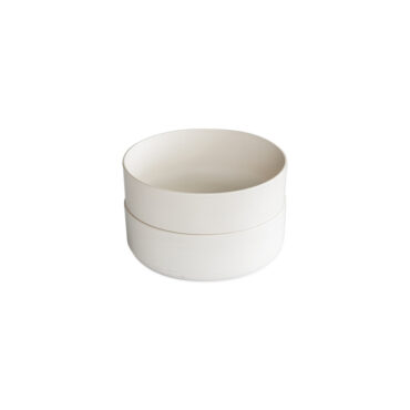 Two white ceramic Nordic Ware soup and salad bowls stacked, round with wide rims and smooth finish