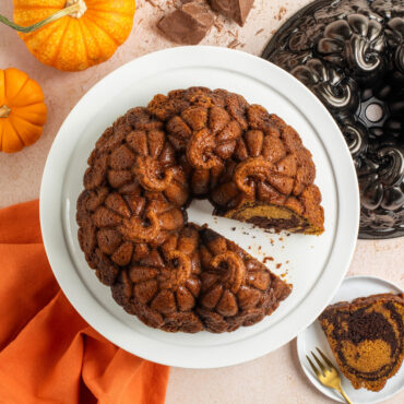 Pumpkin Patch Bundt on cake stand with piece cut out, overhead