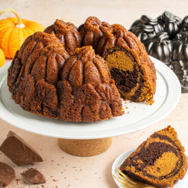 Pumpkin Patch Bundt on cake stand with piece cut out showing swirl pattern