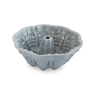 Nordic Ware Very Merry Bundt pan interior showing detailed holly leaf and berry pattern, cast aluminum with silver finish