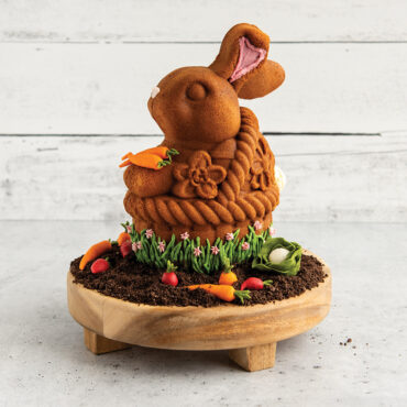 Golden-brown bunny-shaped cake in woven basket design from Nordic Ware aluminum 3D baking pan