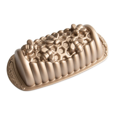 Nordic Ware aluminum loaf pan with honeycomb hexagonal pattern design, gold-colored non-stick interior