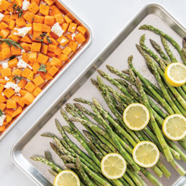 Nordic Ware aluminum half sheet and quarter sheet pans with roasted vegetables, natural silver finish