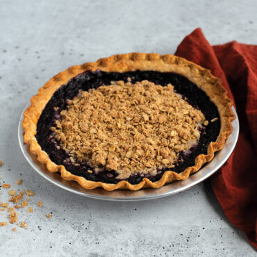 Baked blueberry crumble pie in Nordic Ware aluminum 9-inch pie pan with natural silver finish