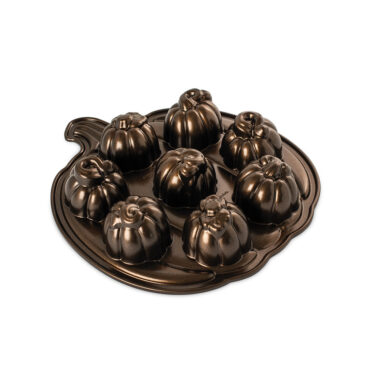 Nordic Ware aluminum Lil' Pumpkin Cakelets pan with 12 pumpkin-shaped cavities, natural finish, angled view