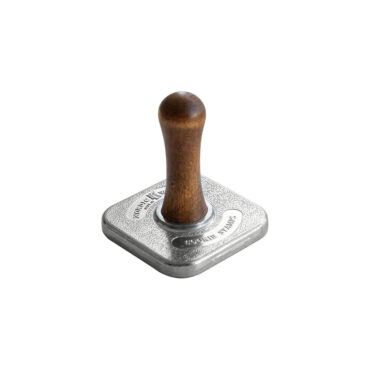 Set of four wooden-handled cookie stamps with carved gingerbread designs on white background