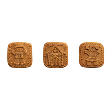 Nordic Ware aluminum cookie stamps creating detailed gingerbread cookies with festive holiday designs