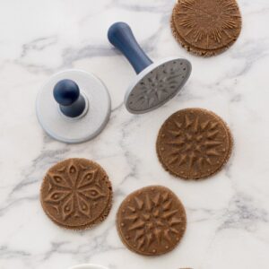 Two Starry Night Cookie Stamps next to 4 stamped cookies featuring Starry Night Cookie Stamp designs.