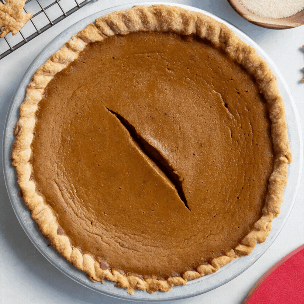 Gif of pie crust leaves covering the top of a Maple Pumpkin Pie with Brown Sugar Crust in the Nordic Ware Naturals® 9" Pie Pan until half of the pie is covered.