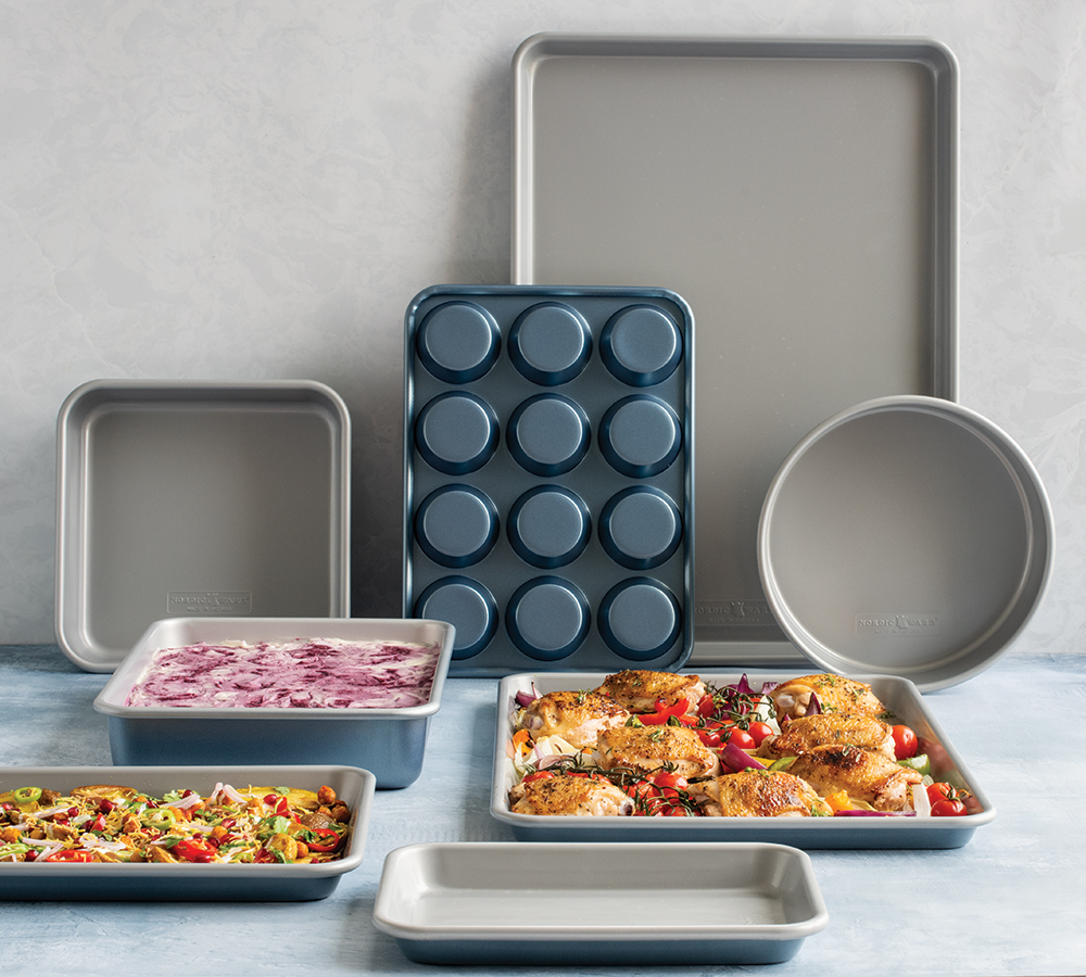 Group of Brilliant Bakeware in kitchen scene, pans with food.