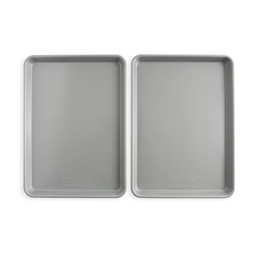 Two Nordic Ware aluminum half sheet pans with nonstick coating, rectangular with raised rims, natural finish