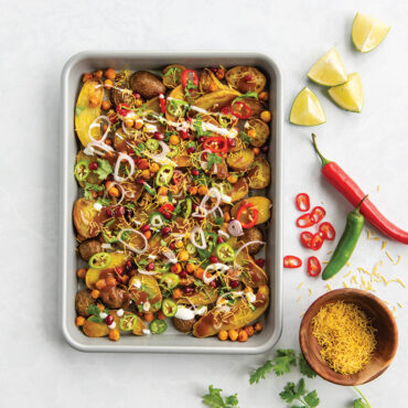 Nordic Ware nonstick quarter sheet pan with golden roasted potatoes and colorful vegetable toppings
