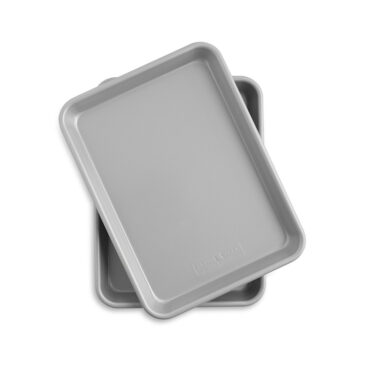 Two Nordic Ware nonstick quarter sheet pans stacked, rectangular aluminum baking pans with dark coating