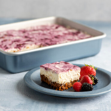 Nordic Ware nonstick 9x13 baking pan with rippled bottom bars, dark coating, one chocolate bar in foreground