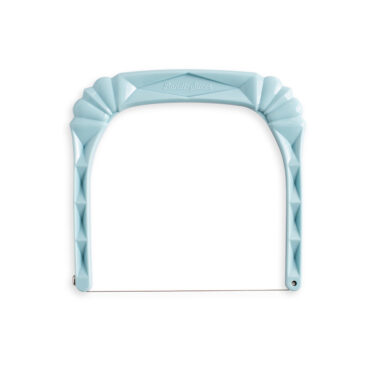 Nordic Ware white plastic bundt slicer tool with curved cutting guide and ergonomic handle