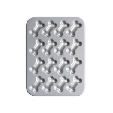 Nordic Ware red nonstick treat pan with 12 bone-shaped cavities, silver interior coating visible