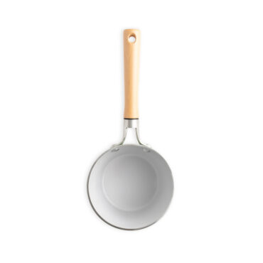 Nordic Ware 1.5-quart ceramic nonstick saucepan interior view, cream-colored coating with black rim