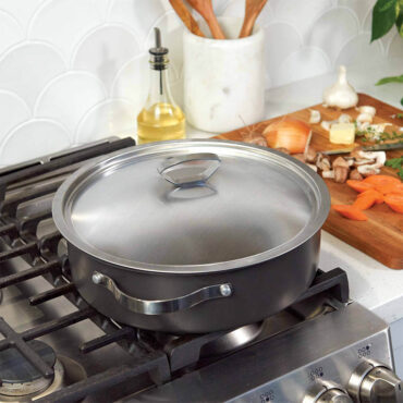 Nordic Ware Verde green ceramic braiser pan with matching lid on stovetop