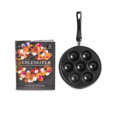 Nordic Ware cast aluminum Ebelskiver pan with seven rounded wells and accompanying Aebleskiver cookbook on white background