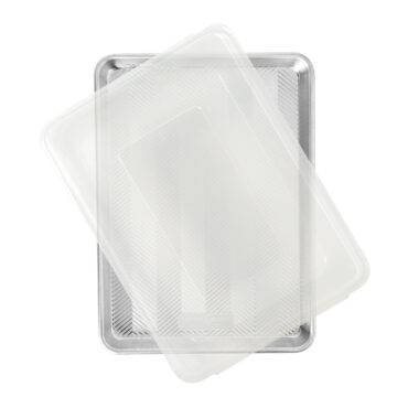 Nordic Ware aluminum half sheet baking pan with clear plastic lid, rectangular with raised rim, natural silver finish