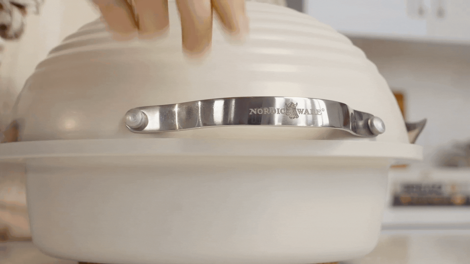 Artisan-quality results. Hands adding a lid to the Simply Sourdough Bread Baking pan with sourdough dough inside, transferring the pan to the oven then removing the pan from the oven with perfectly cooked bread inside. Hands remove the cooked loaf from the pan using the silicon bread sling. 